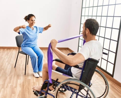 Patient using resistance bands in physical therapy.