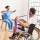 Patient using resistance bands in physical therapy.