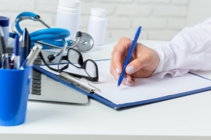 Doctor signing a form