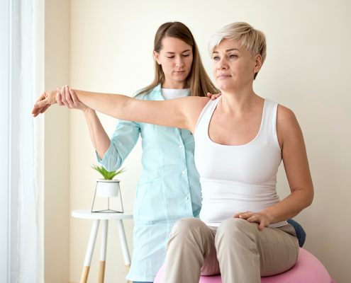 Therapist demonstrating proper posture during physio.