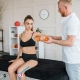 Physical therapist guiding rehabilitation with exercise weight